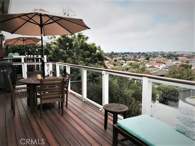 glass panel balcony with lovely view of hills and enchanting sunset