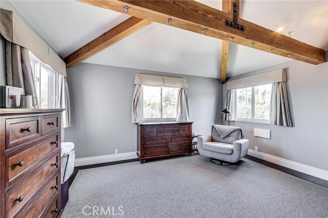 Bedroom #4. Windows facing 3 directions provide all kinds of sunlight. Massive beams and vaulted ceilings give this room lots of volume!