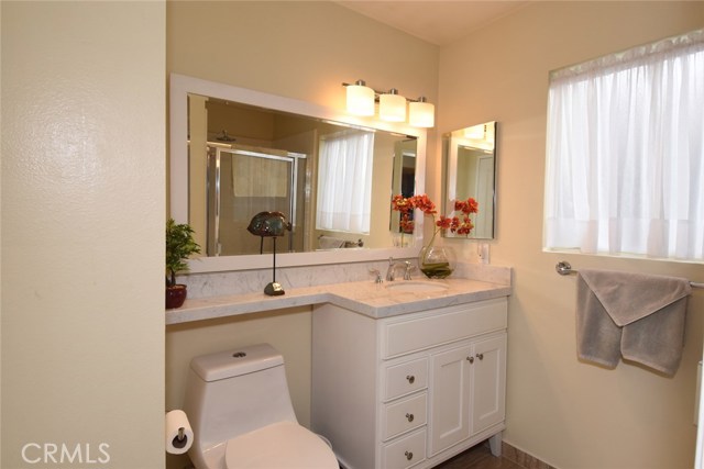 One of the master bedroom's beautiful bath areas (there are 2).  Lovely new vanity with carrara marble counters, new sink, faucet, tile floors, and lighting.