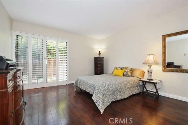 Comfortable second bedroom with wood floors and Plantation shutters. Both bedrooms at Unit 107 open onto your 