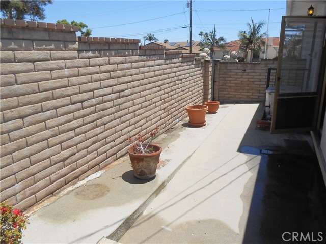 Full Block Wall on Side of house with easy to Maintaining Cement Side-yard.