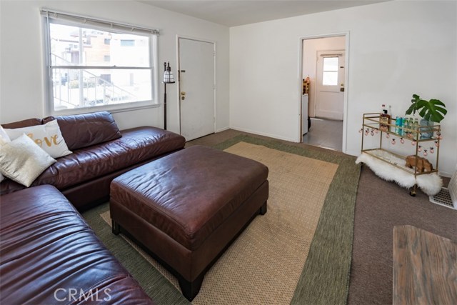 Living room with view to front door and kitchen side door