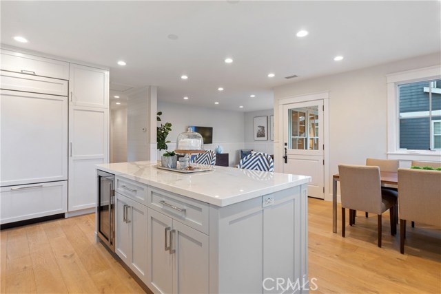 The show-stopping kitchen is upgraded to perfection with custom cabinetry and island by His Life, a built-in Sub-Zero refrigerator, Wolf 6-burner range, countertops by Neolith, and thoughtful conveniences where no detail has been spared.