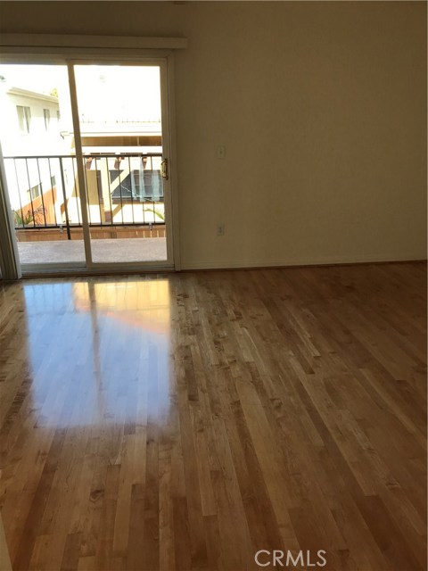 Spacious master bedroom with high wood beam ceilings.