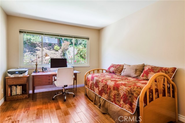 Bedroom #4 on the back of the home has hardwood floors and view of the gorgeous backyard.