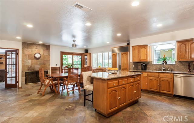Enormous island kitchen/great room has LED lighting, slate floors, stainless steel appliances inc new cooktop, Sub-Zero fridge, wine fridge, convection oven/microwave, greenhouse window &
French door slider that opens to patio and gas fireplace.