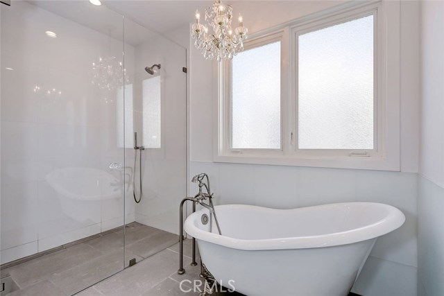 Master bath includes soaking tub and curbless shower with infinity drain