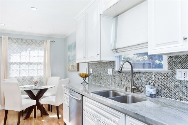 Quartz counters, dual sink, stainless steel appliances, wood cabinets.