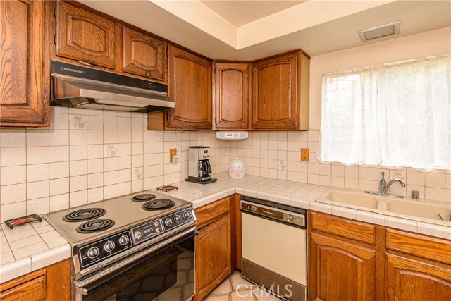 Wood cabinets , dishwasher and hood vent for the stove!