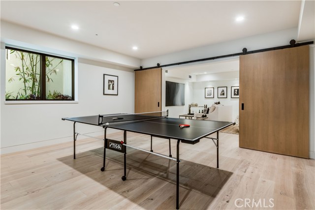 this large entertaining space has unique sliding doors and enjoys plenty of space for a game room