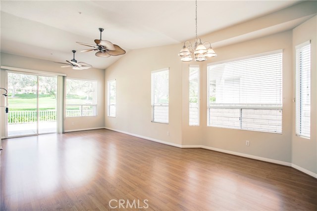 Open layout living room and dining room with ceiling fans