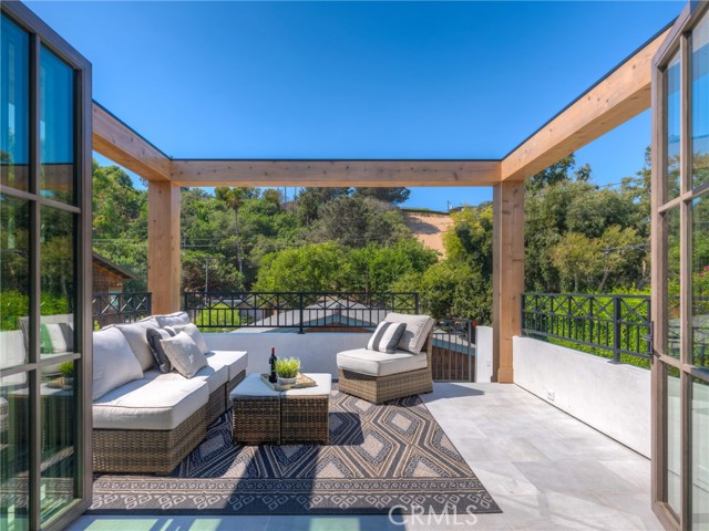 Private guest/in-law suite above the 3 car garage with outdoor sitting/patio area.  LaCantina door systems for the perfect indoor/outdoor experience.  Views of Sand Dune Park and just minutes from the beach.