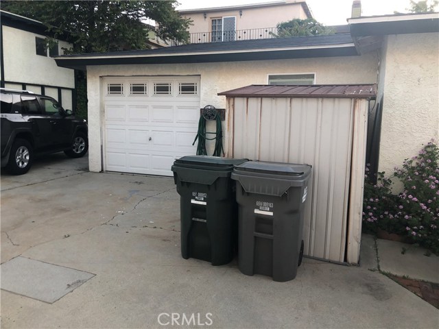 Back of front house and Garage, please note that the front unit is using the 1 car garage is being used as a converted bedroom/laundry  and that  garage door has been stuccoed over