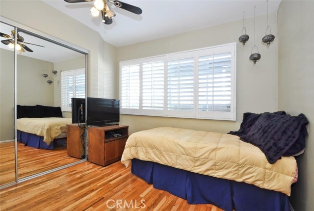 Bedroom #4 has hardwood floors, mirrored closet doors and  large window