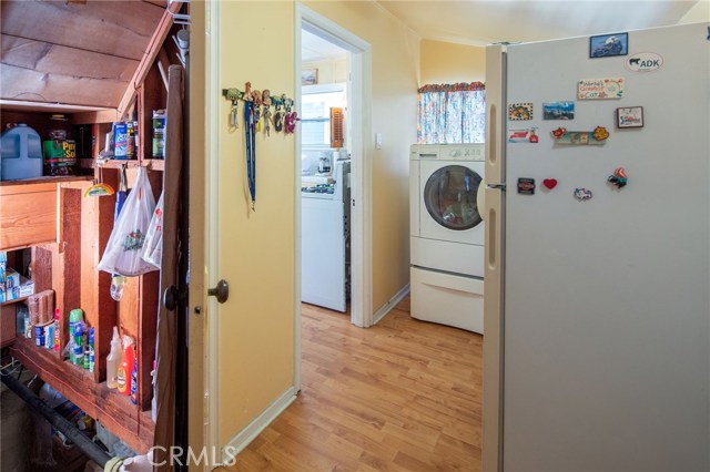 Laundry room adjacent to kitchen with access to basement.