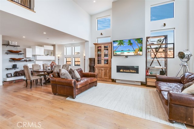 Living and dining areas showing the floor to ceiling fireplace