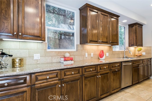 Updated kitchen features expansive granite countertops.