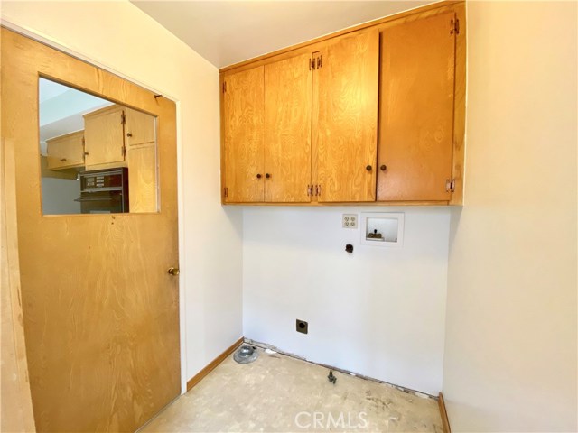 Interior Laundry between Kitchen and Bathroom #1.  Exterior Door to side of home.