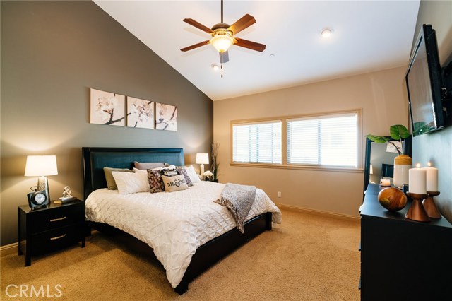 The master bedroom suite with tall vaulted ceilings, a luxurious master bath with dual vanities, jetted tub, and a large walk-in closet is a peaceful retreat.