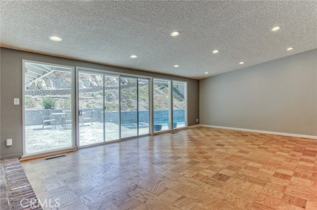 Living room with wall-to-wall glass and sliding doors to enjoy the outdoor view