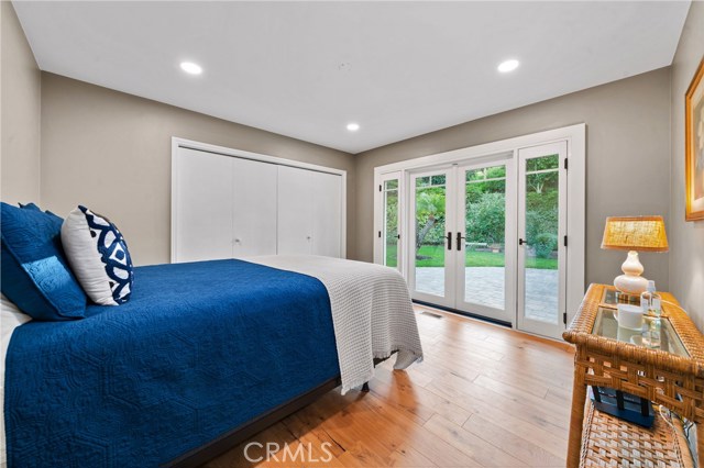 Upstairs bedroom with French doors leading to backyard.