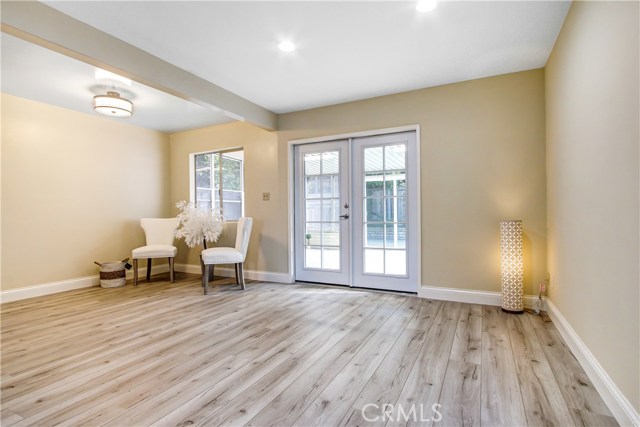 Just painted, recessed lighting , new laminate flooring , french doors to outside and Dual paned windows !!