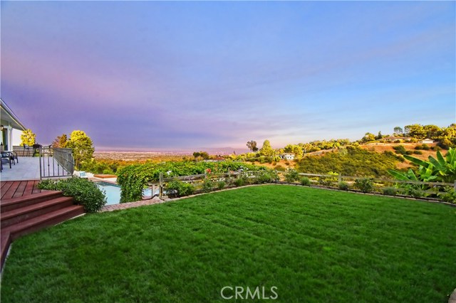 Flat backyard grass area connecting to Master Suite, balcony and stairs away from pool