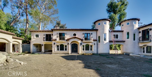 Two buildings connected by a bridge adorned with two towers.  8-car garage including a 4-car garage plus 2 car garage on each building.