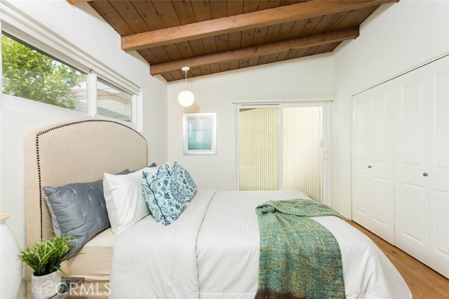 Master bedroom with sliding glass door to backyard.