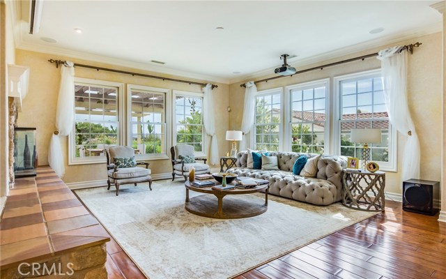 Large family room with huge drop down movie screen. There are ocean views, views of the Pt Vicente lighthouse, and open floorplan into the kitchen.