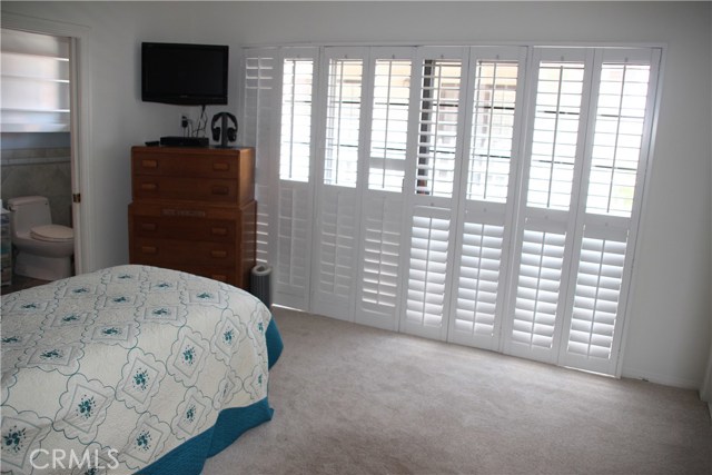 Master bedroom with new carpet, paint and plantation shutters.