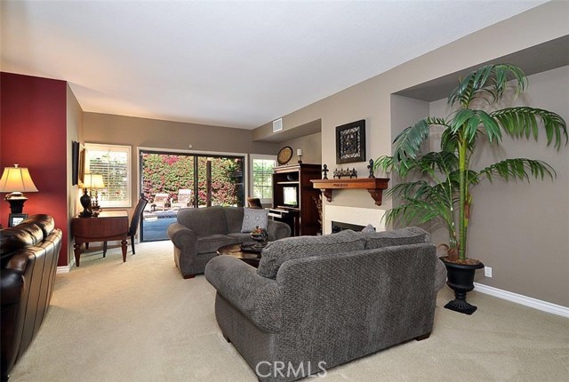 View of living area with fireplace and access to private yard