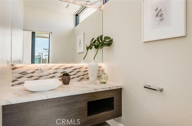 This powder room serves the upper level