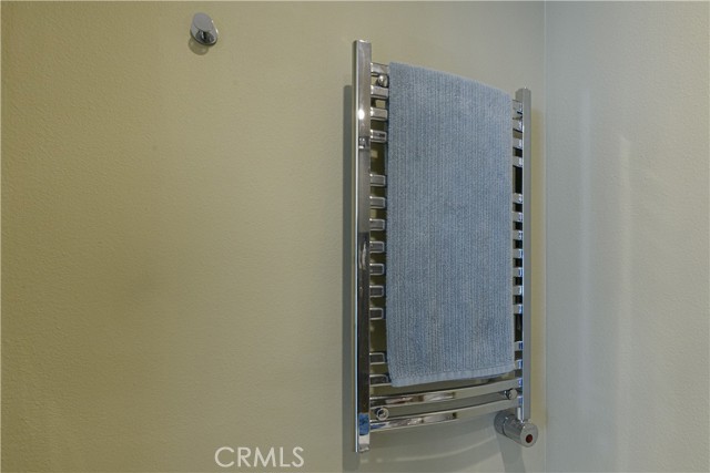Towel Warmer--control can be programmed to turn on and off at desired times each day
