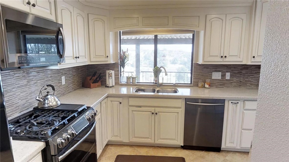 Living Room Enjoys Wonderful Views and Vaulted Wood Beamed Ceilings!