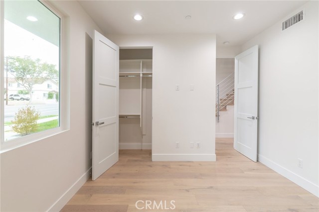 Spacious bedroom with built-in closet features