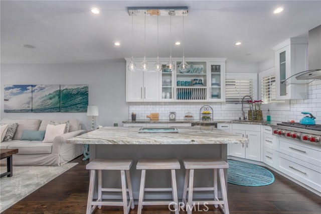 Kitchen with custom shaker cabinets, several with glass fronts.