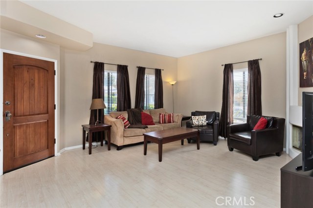 Living area features plenty of windows, fireplace and recessed lighting.