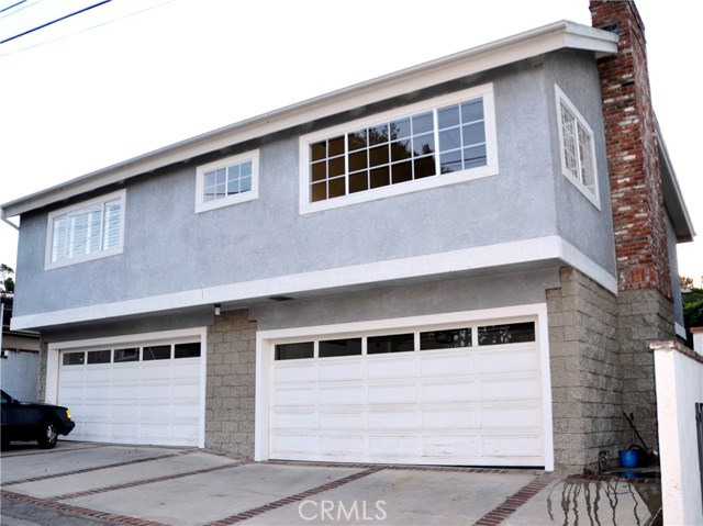 Rear view of the home. Two car garage opens directly to the home and a entry foyer.