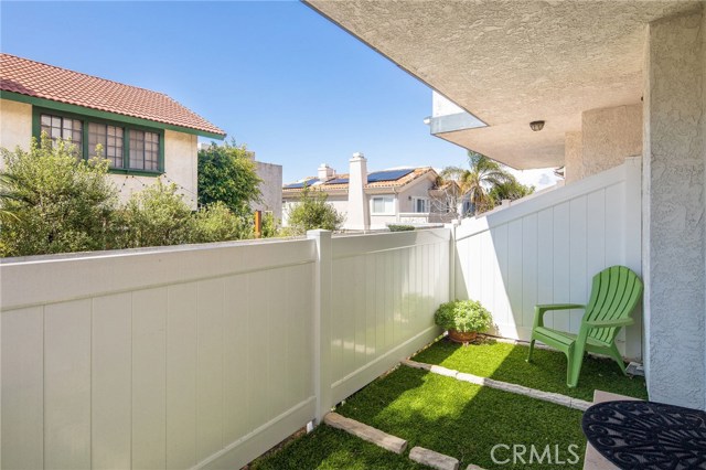 Fenced, private patio is accessible from front bedroom