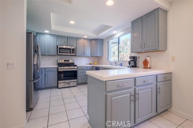 Bright kitchen with custom painted cabinetry throughout. Stainless Steel Appliances.