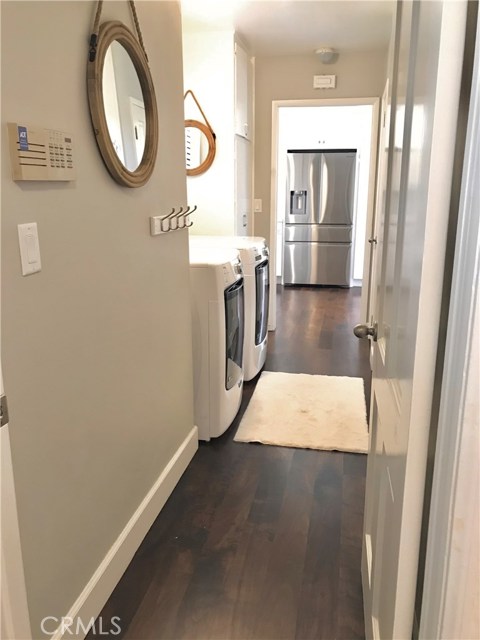 Laundry room with tons of storage cabinets, pantry, and brand new water heater in dedicated closet.