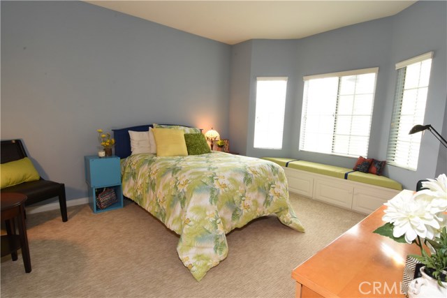 Bedroom #2 is sunny and overlooks the exterior entryway.  Adorable window bench with storage below!