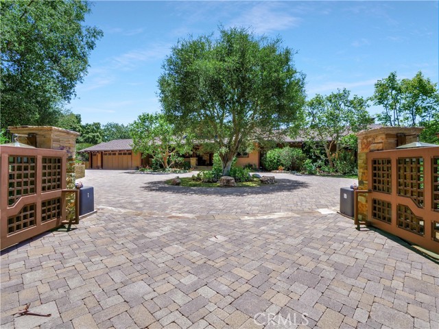 Front of Craftsman-style home up to private entry gates.