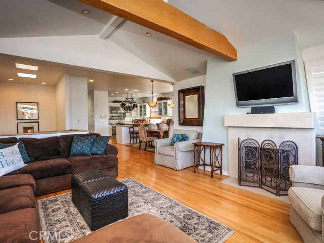 The living room opens up to the kitchen, dining area and upper patio.