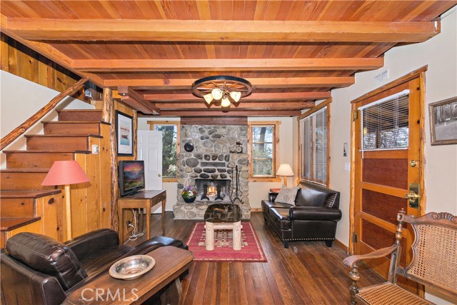 Family room with lovely fireplace and hardwood floors