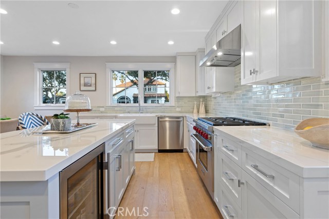 The show-stopping kitchen is upgraded to perfection with custom cabinetry and island by His Life, a built-in Sub-Zero refrigerator, Wolf 6-burner range, countertops by Neolith, and thoughtful conveniences where no detail has been spared.