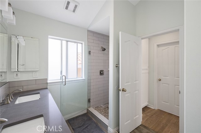 Dual vanity sinks, separate shower, linen storage, & walk in closet