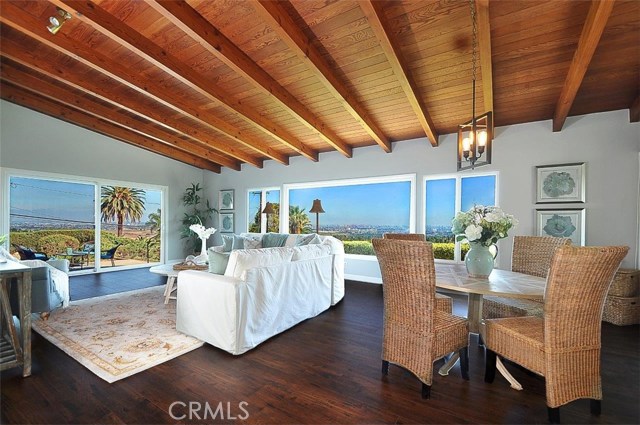 Family room with game table or study area showing views and doors to the side patio.