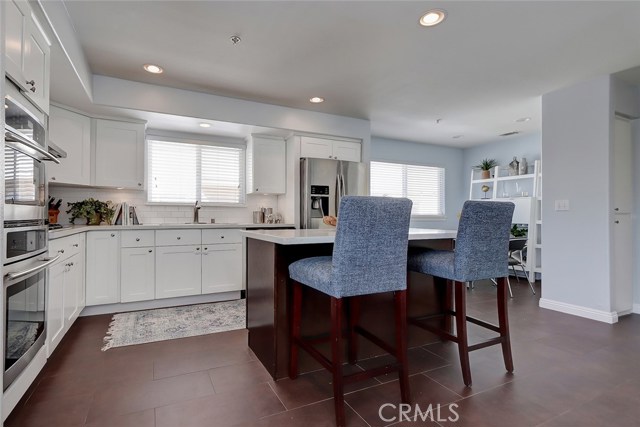 Remodeled kitchen with quartz countertops, stainless steel appliances and recessed lighting.